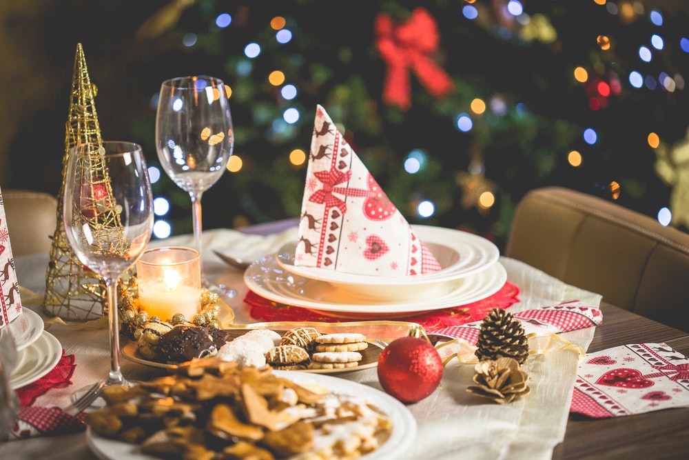 christmas themed table with empty wine glasses