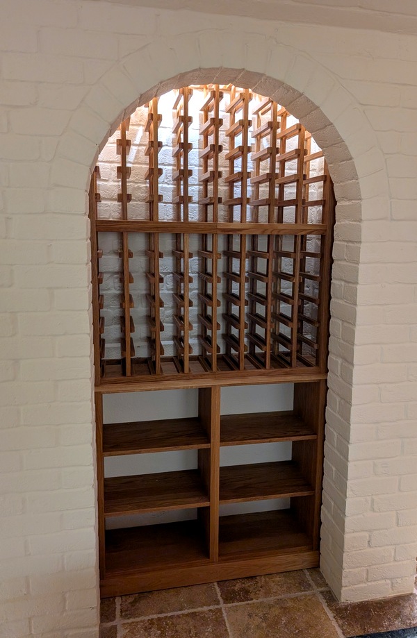 white brick wall with curved wine rack in danish oil