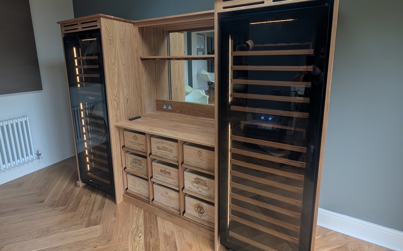 a solid oak wine wall with tall fridges